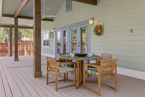 a wooden table and chairs on a porch at Spacious, Peaceful, Historic - 3 Minute Walk to the Square in Georgetown