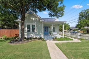a small green house with a white fence at Spacious, Peaceful, Historic - 3 Minute Walk to the Square in Georgetown