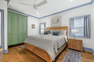 a bedroom with a bed and green cabinets at Spacious, Peaceful, Historic - 3 Minute Walk to the Square in Georgetown