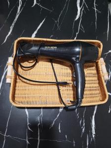 a black hair dryer sitting on top of a counter at Bae Homestay Taman Mega Alor Setar Wi-Fi Netflix 