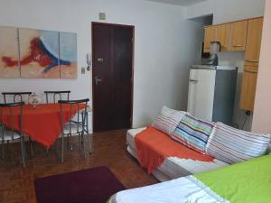 a living room with a couch and a table at Kitnet in Praia Grande