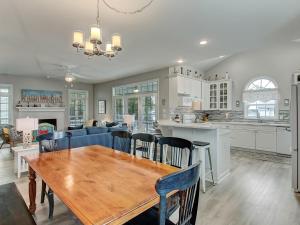 a kitchen and living room with a wooden table and chairs at Life's a Beach in Tybee Island