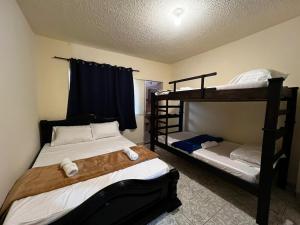 a bedroom with two bunk beds at Casa Rincón in Curití