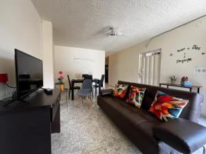 a living room with a couch and a dining room at Casa Rincón in Curití