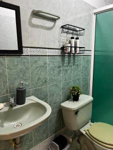 a bathroom with a sink and a toilet at Casa Rincón in Curití +8 photos