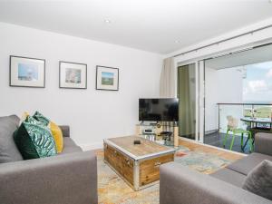 a living room with a couch and a tv at 50 Bredon Court in Newquay