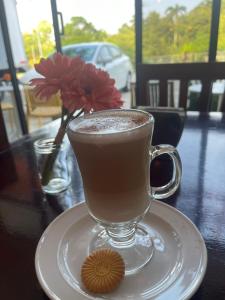 a cup of coffee on a table with a cookie at Hotel Rio Maya in Palenque