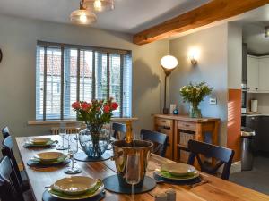 a kitchen and dining room with a table and chairs at Brookfields in Slingsby