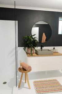 a bathroom with a sink and a mirror at 10 min walk to beach & cafés with a quiet, private fenced garden in Byron Bay