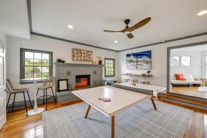 a living room with a ping pong table and a fireplace at Stunning Westhampton Beach Home with Private Pool in Westhampton Beach