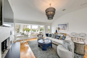 a living room with white furniture and a fireplace at Stunning Westhampton Beach Home with Private Pool in Westhampton Beach