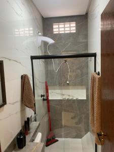 a shower with a glass door in a bathroom at Studio Centro Coité in Conceição do Coité