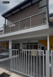 a house with a balcony with a fence at Avida Homestay in Kampong Jelatang