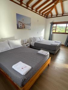 a bedroom with two beds and a window at Villa Ancestral in Villa de Leyva