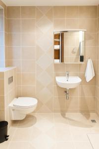 a bathroom with a toilet and a sink at T10 Self check-in Hotel in Hafnarfjördur +5 photos