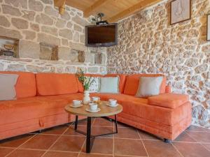 a living room with a couch and a table at Green Paradise with pool in Dropuljići