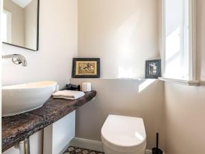 a white bathroom with a sink and a toilet at Wening-Hüs Wening-Hüs , in Boldixum