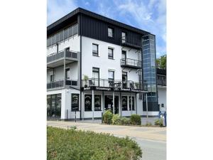a white building with a black roof at Briesenick-Radde in Tossenserdeich