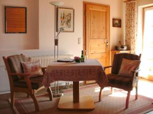 a dining room with a table and two chairs at Holiday apartment with 1 bedroom in Fischbachau