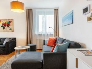 a living room with a couch and a table at Holiday apartment with 1 bedroom in Meersburg