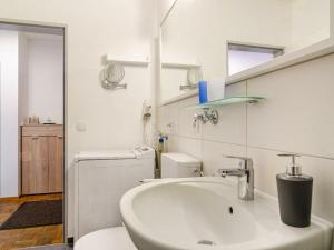 a bathroom with a sink and a washing machine at Holiday apartment with 1 bedroom in Meersburg +29 photos
