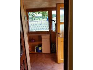 a door leading into a kitchen with a window at To the horse paddock in Zislow +13 photos