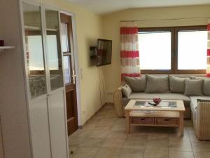 a living room with a couch and a coffee table at To the horse paddock in Zislow