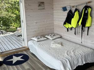a bed with two pillows in a room at 6 person holiday home in SVANESUND in Buvik