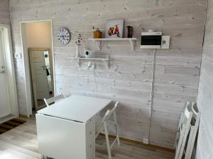 a kitchen with a white table and a wall at 6 person holiday home in SVANESUND in Buvik