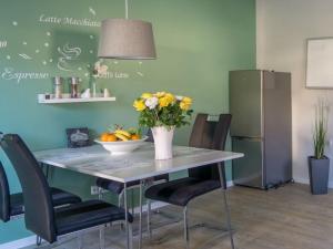 a dining room table with a vase of flowers on it at Spessart Romanticism in Blankenbach