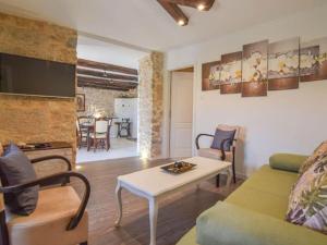 a living room with a couch and a table at Villa in Zagvozd with swimming pool in Vranješi