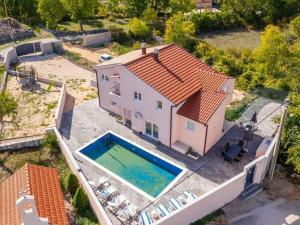 an aerial view of a house with a swimming pool at Cecilia with pool in Nenadići