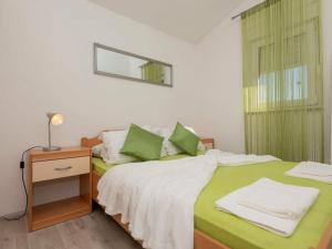 a bedroom with two beds with green sheets and a mirror at Cecilia with pool in Nenadići +32 photos