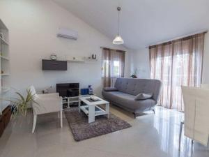 a living room with a couch and a table at Cecilia with pool in Nenadići