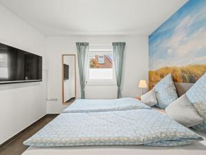 a white bedroom with a large bed and a window at Holiday home in Timmel with swimming pool in Timmel