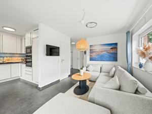 a living room with a couch and a table at Holiday home in Timmel with swimming pool in Timmel