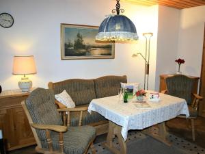 a living room with a table and two chairs and a lamp at Gentian in the Wendelstein holiday home in Fischbachau