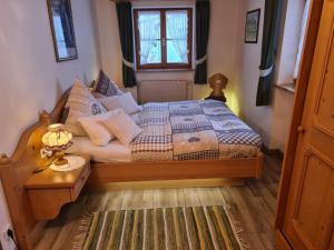 a bedroom with a bed and a window at Gentian in the Wendelstein holiday home in Fischbachau