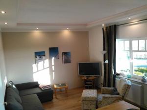 a living room with a couch and a tv at Holiday apartment with 2 bedrooms in Sinsum