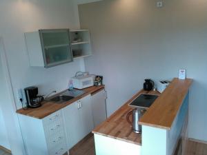 a small kitchen with a sink and a counter at Holiday apartment with 2 bedrooms in Sinsum +13 photos