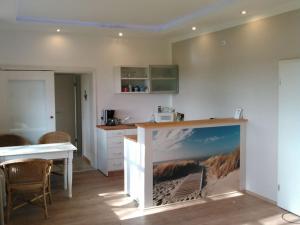 a kitchen with a large picture on the wall at Holiday apartment with 2 bedrooms in Sinsum