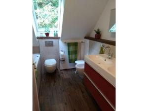 ein Badezimmer mit Toilette und Waschbecken und einem Fenster in der Unterkunft Holiday home in Hornberg with swimming pool in Niederwasser + 14 Fotos