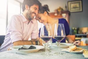 a man and woman sitting at a table with wine glasses at Pet-Friendly Napa Retreat Wineries Downtown in Vichy Springs