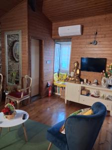 a living room with a couch and a tv at Casa do Vale Encantado in Cedovim