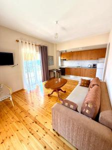 a living room with a couch and a table at Janakis Apartments in Himare