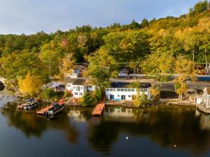 an aerial view of a house on the water at Modern Winnipesaukee Lake Front Retreat Siena in Alton