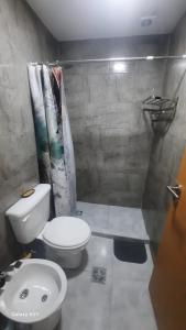 a bathroom with a white toilet and a sink at Rada Tilly Apart 2 Unidad 6 in Rada Tilly