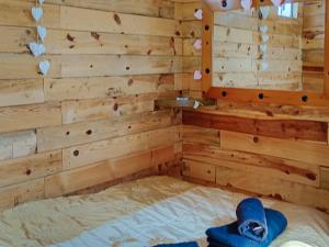 a bedroom with a bed in a log cabin at The Box - Oasis Farm in Fareham