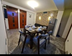 a dining room with a table and chairs and a refrigerator at Departamento en Nuevo Chimbote in Chimbote +22 photos