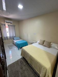 a bedroom with two beds in a room at Quarto em Belém - Próximo ao Mercado de São Brás in Belém